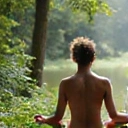 A person meditating peacefully in a natural setting, radiating calm and balance, representing holistic well-being.